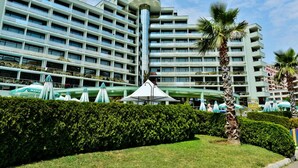 A multi-story hotel with a modern design, featuring balconies and a central atrium. - Marvel (Nessebar)