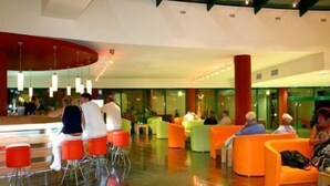 A modern lobby with orange seating areas and a glass partition. - Marvel (Nessebar)