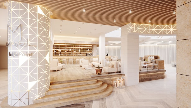 A modern hotel lobby with a central seating area, a bar, and a staircase leading to an upper level. - Marvel (Nessebar)