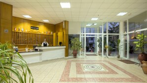 A reception area with a reception desk, a sign indicating 'RECEPTION', and potted plants. - Corali Hotel (Kos)