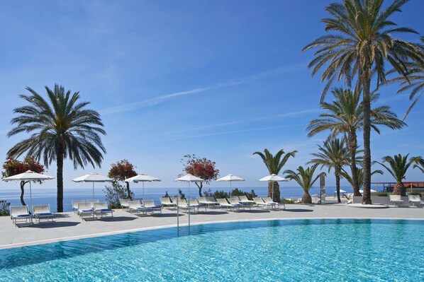 Indoor pool, outdoor pool, pool umbrellas, pool loungers