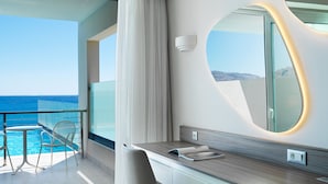 A modern hotel room with a balcony overlooking the sea, a large mirror, and a wooden vanity. - Rodos Princess Beach Hotel - All Inclusive (Rhodes)