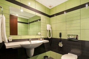 A bathroom with a large sink, a mirror, a hairdryer, and a toilet. - Hotel Lion Sunny Beach (Sunny Beach)