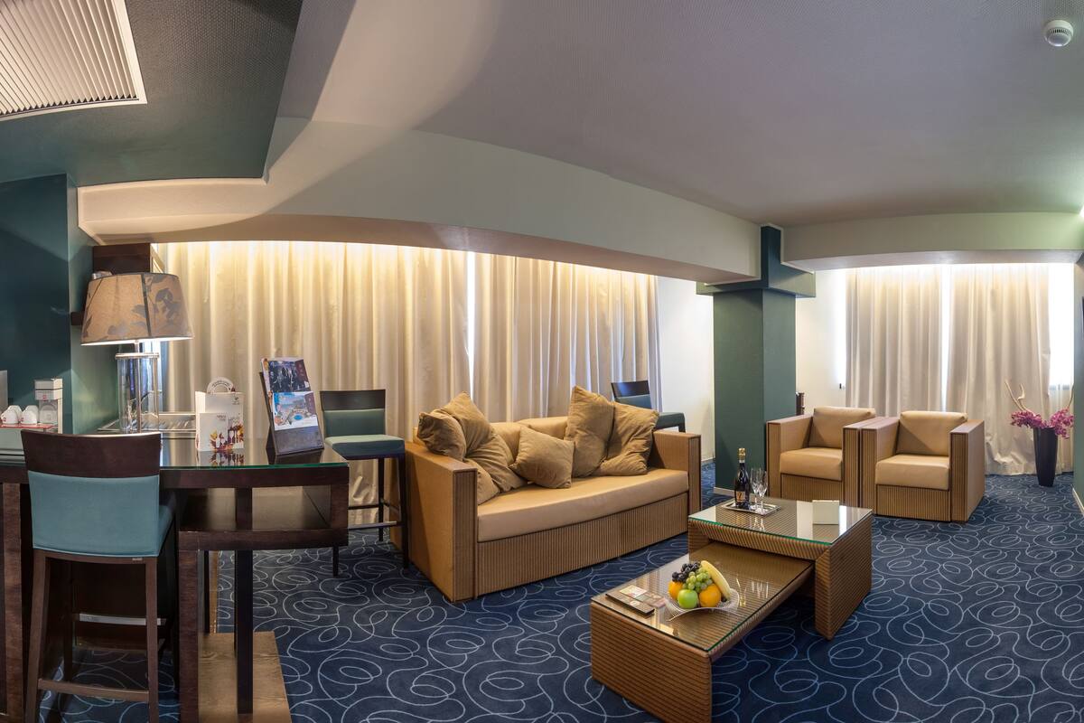 junior suite, 1 king bed (lateral sea view) | living area | lcd tv