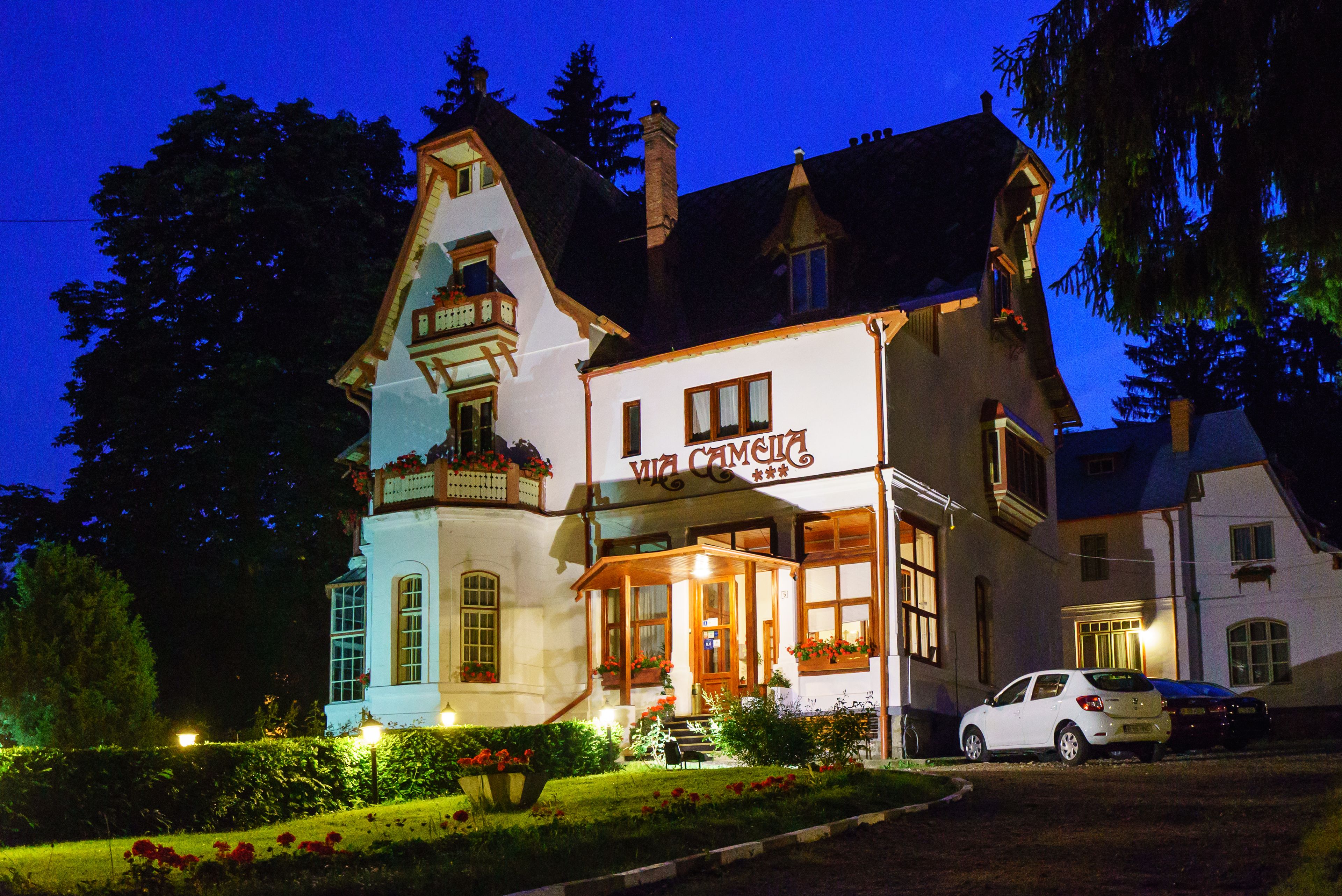 A two-story building with a sign reading "VIA CAMELIA" at the entrance.