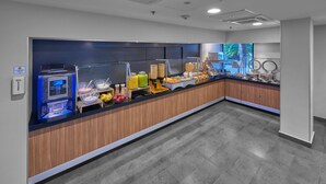 A modern breakfast bar with a self-service coffee machine, various food options, and a clean, tiled floor. - City Express by Marriott Tijuana Río (Tijuana)