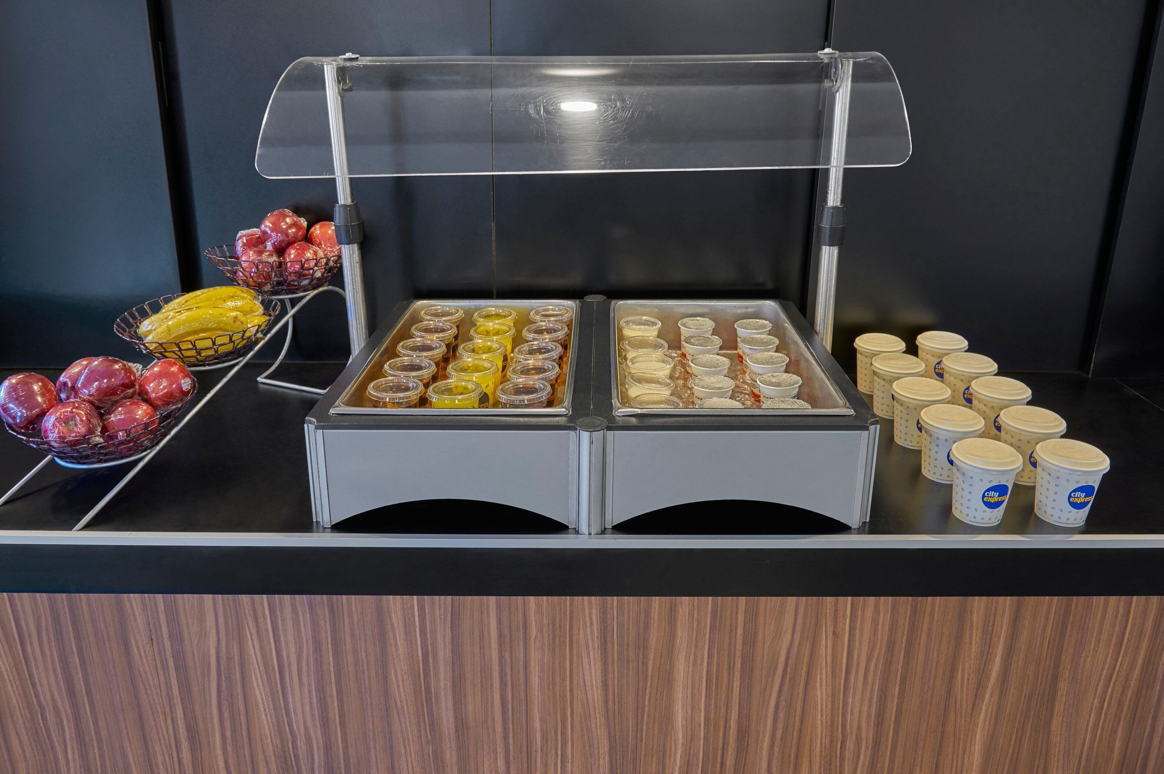 A buffet with various food items and containers.