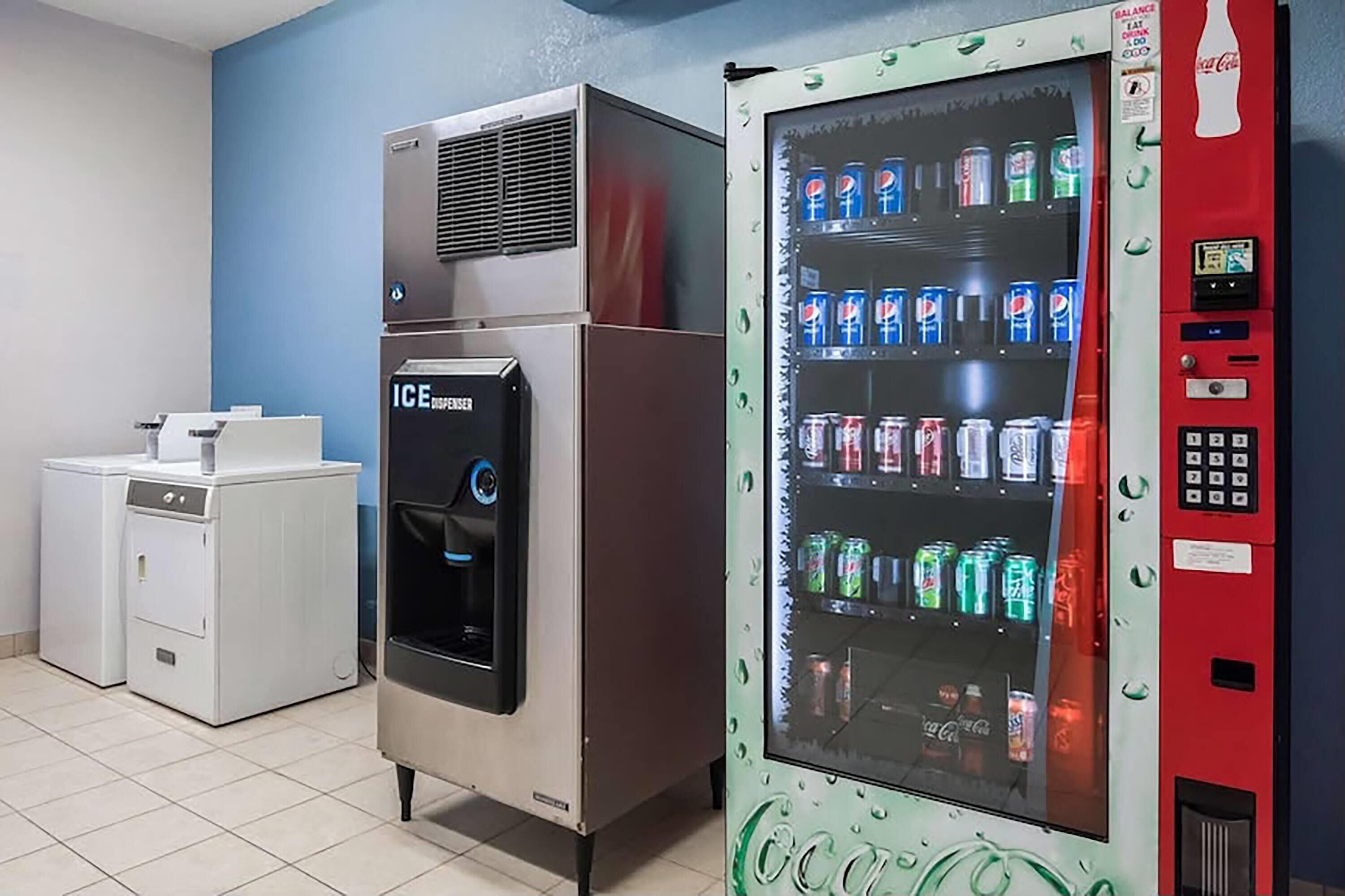 A vending machine with a Coca-Cola logo and a water dispenser with an Ice Jensen logo.
