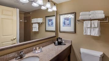 A bathroom with a sink, mirror, towel rack, and toilet.