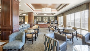 A spacious lobby with a bar area, seating arrangements, and large windows providing natural light. - Best Western Plus Ponderay Mountain Lodge (Ponderay)