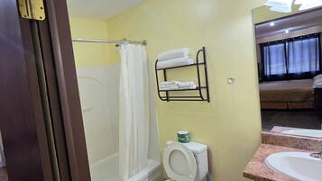 A bathroom with a bathtub, toilet, and a sink.