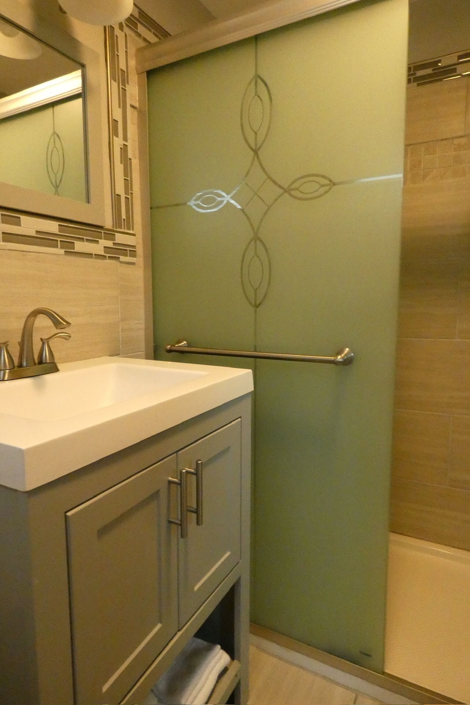 A bathroom with a white sink, a mirror, a towel rack, and a shower area.