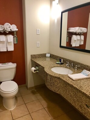 A bathroom with a toilet, sink, and towel rack. - Garner Hotel Lawton Fort Sill Area by IHG (Lawton)
