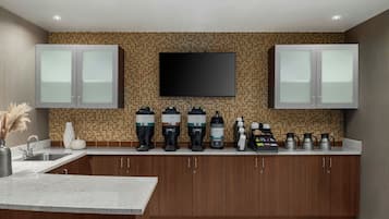 A modern kitchen with a tiled backsplash, stainless steel appliances, and wooden cabinets.
