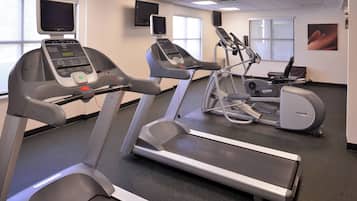 A fitness center with treadmills, an elliptical, and a stationary bike.