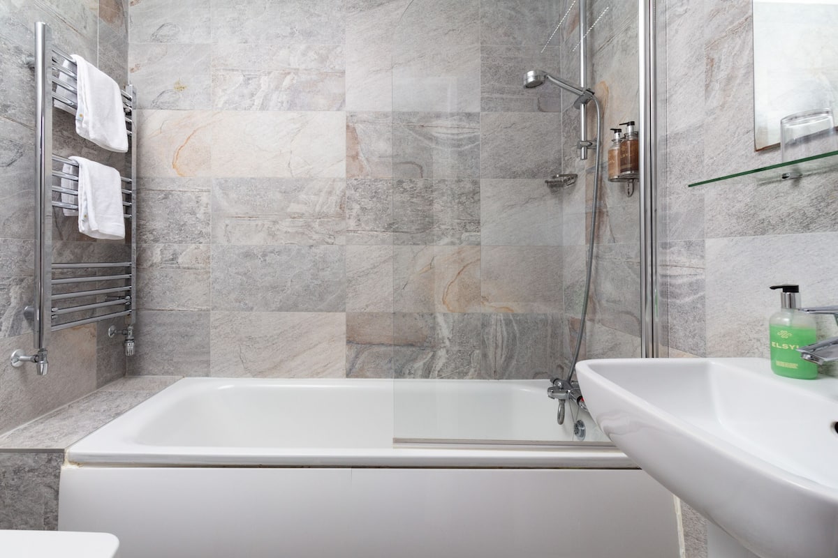 shower, designer toiletries, hair dryer, towels