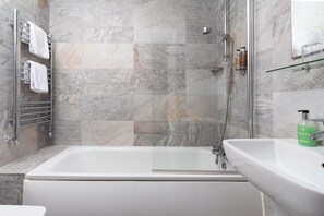 Shower, designer toiletries, hair dryer, towels