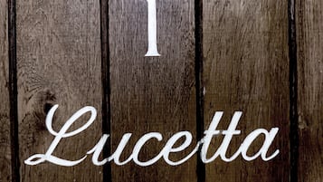A wooden sign with the number 1 and the name 'Lucetta' written on it.