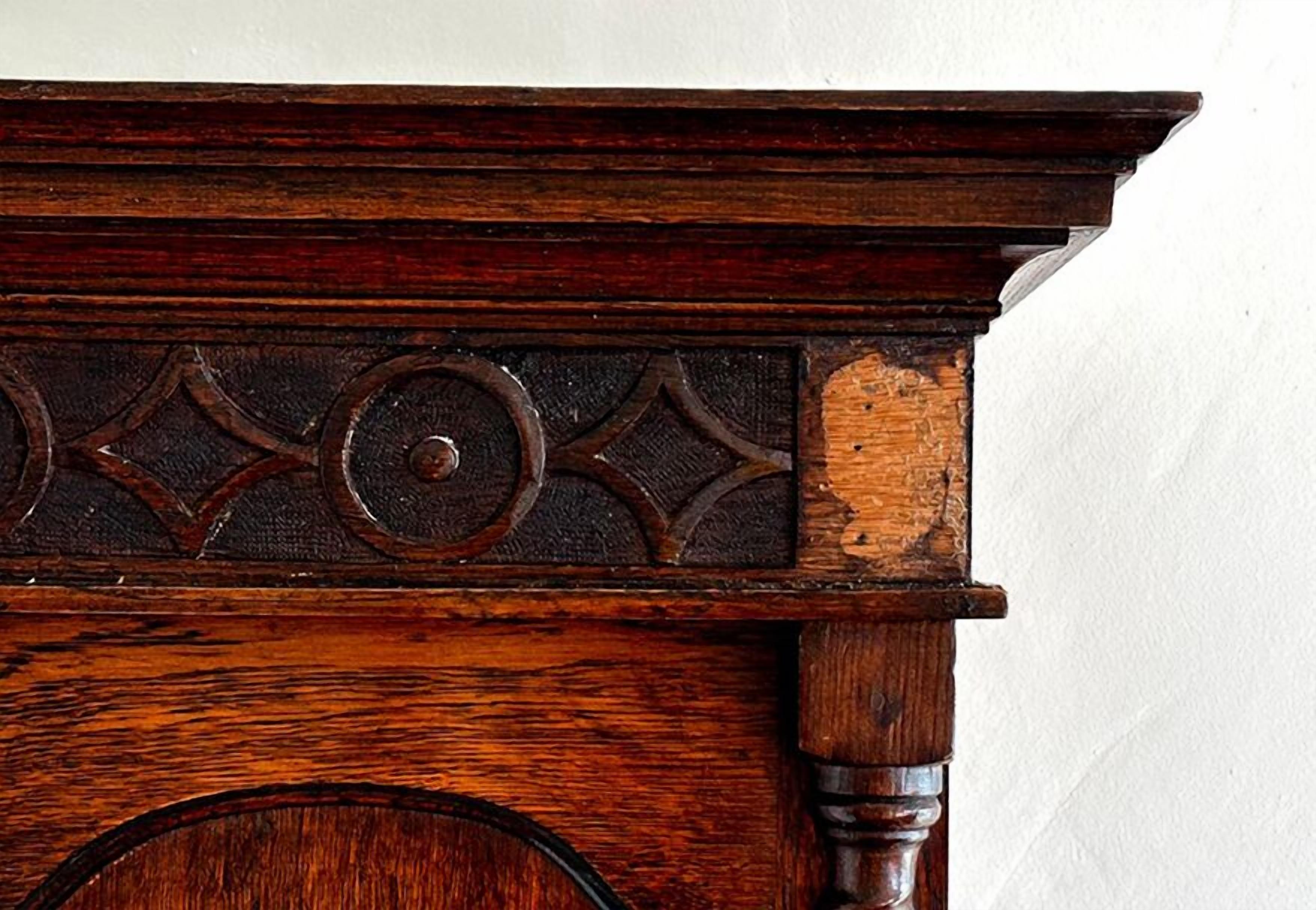 A wooden piece with carved geometric patterns and a circular design.