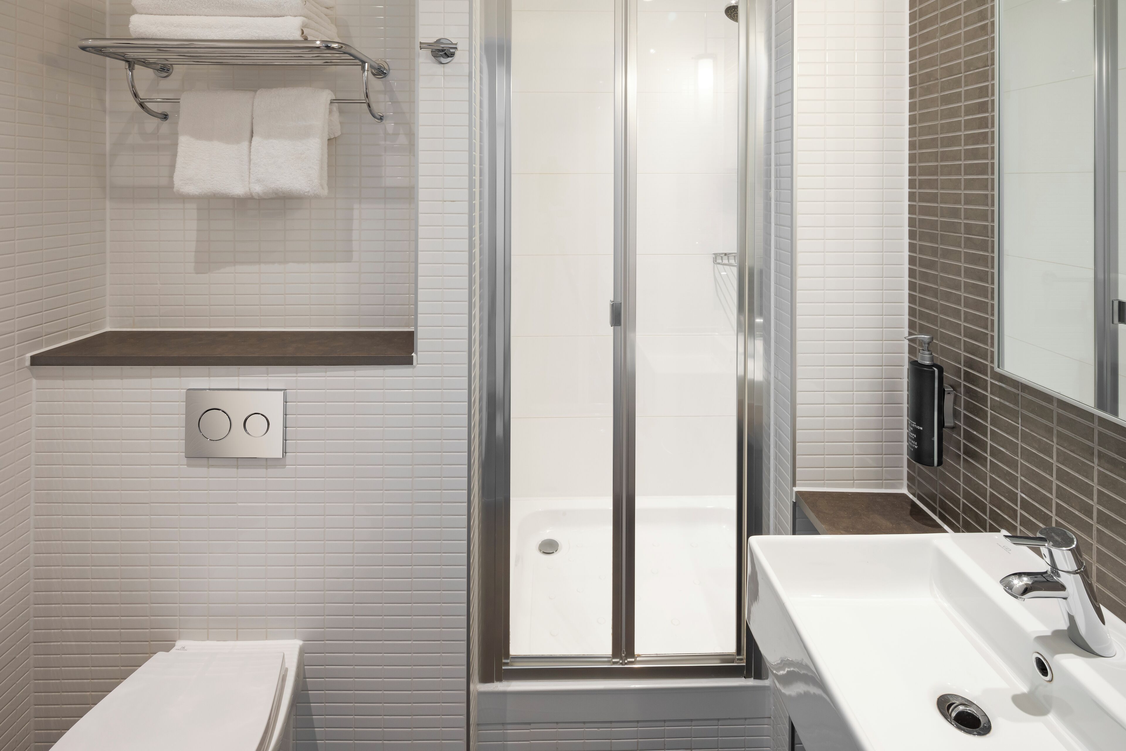 deluxe room, 1 king bed | bathroom | designer toiletries, hair dryer, towels