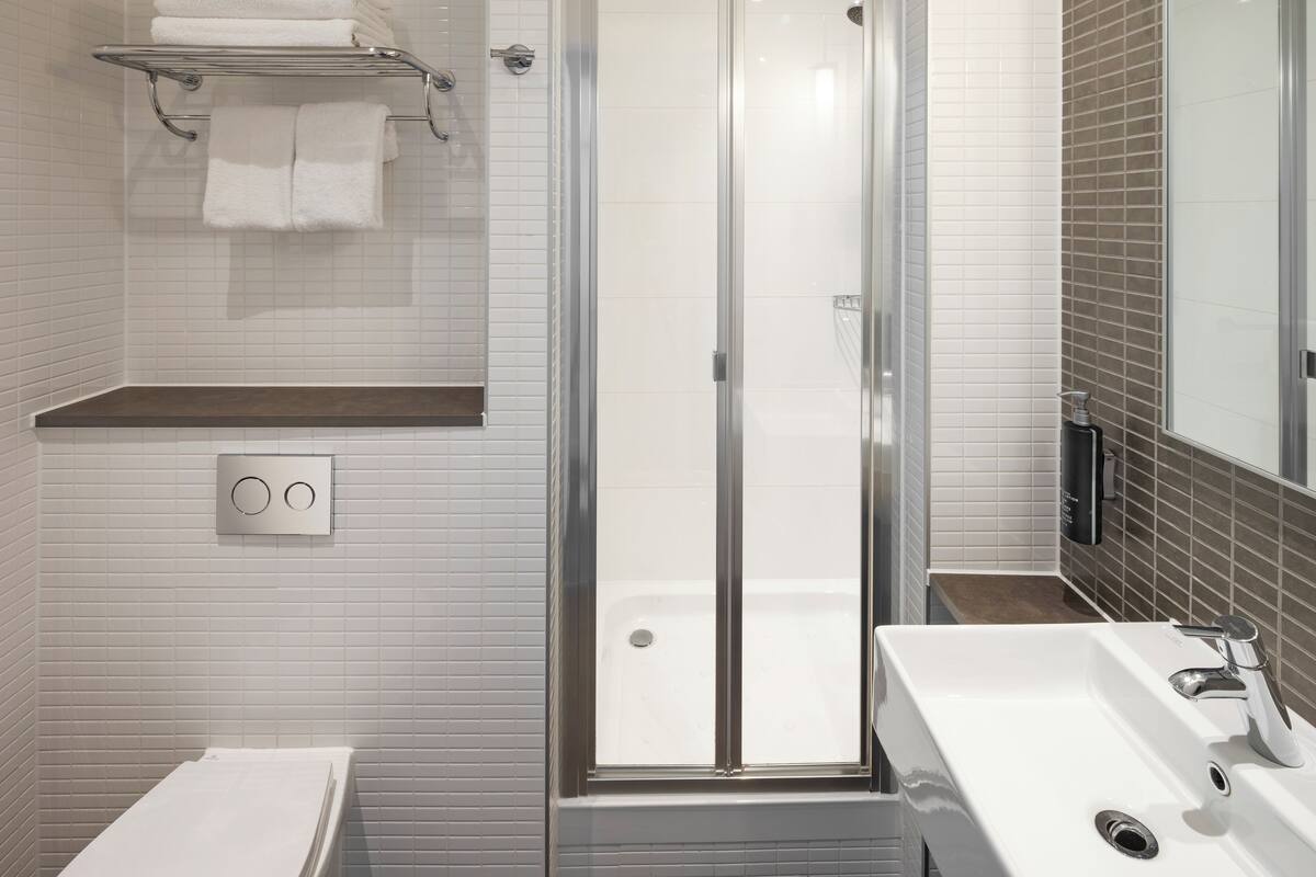 deluxe room, 1 king bed | bathroom | designer toiletries, hair dryer, towels