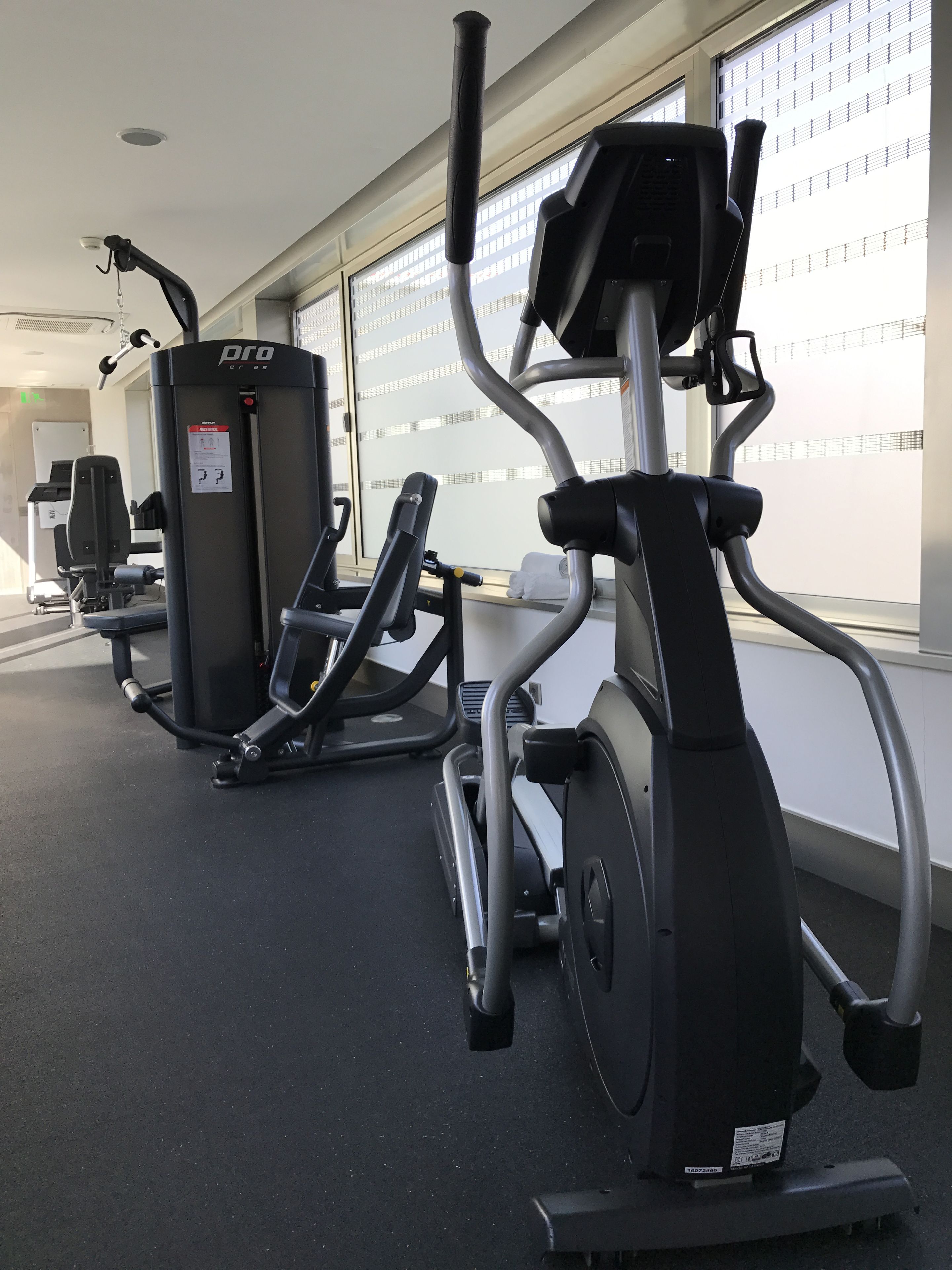 A gym with stationary bikes and a weight machine.