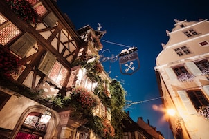 A traditional European building with a sign indicating a hotel.