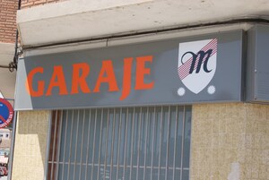 A garage sign with the word "GARAGE" and a logo.