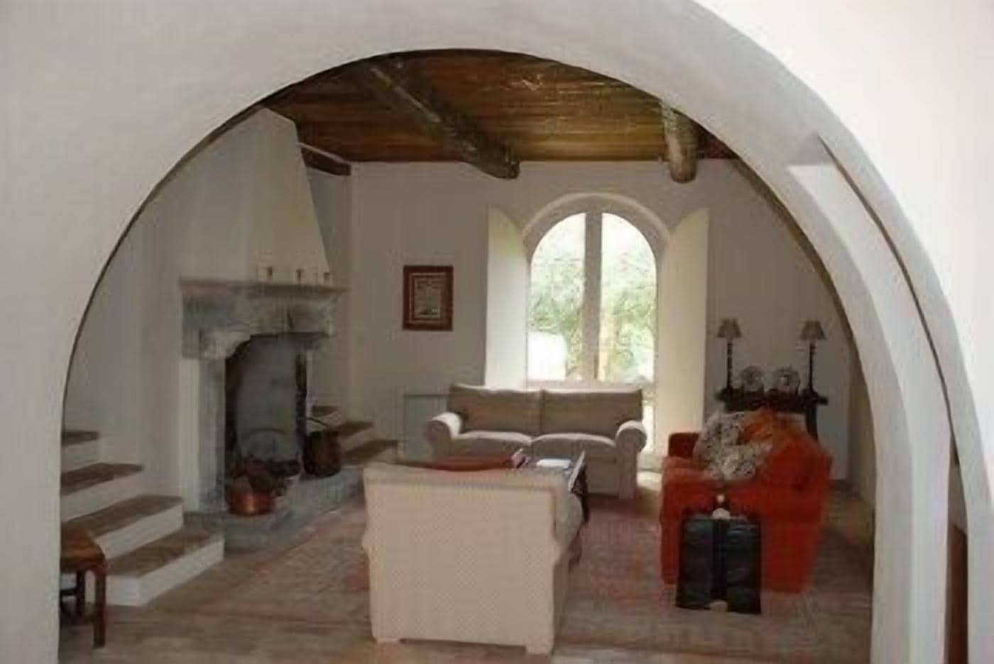 A cozy living room with a fireplace, a sofa, and a coffee table.