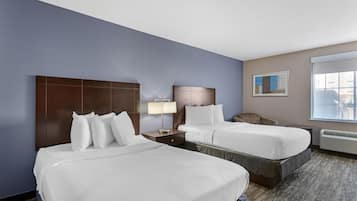 Premium bedding, desk, laptop workspace, blackout drapes