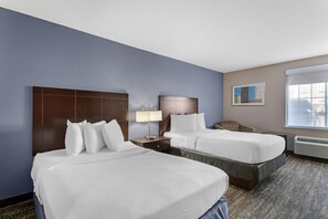 Premium bedding, desk, laptop workspace, blackout drapes