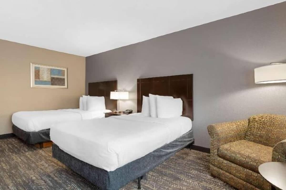 Premium bedding, desk, laptop workspace, blackout drapes