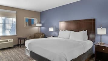 Premium bedding, desk, laptop workspace, blackout drapes