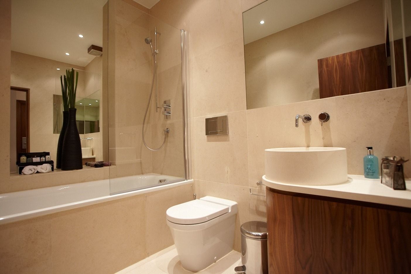 A modern bathroom with a bathtub, toilet, and sink.