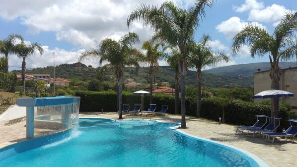 Outdoor pool, pool umbrellas, sun loungers