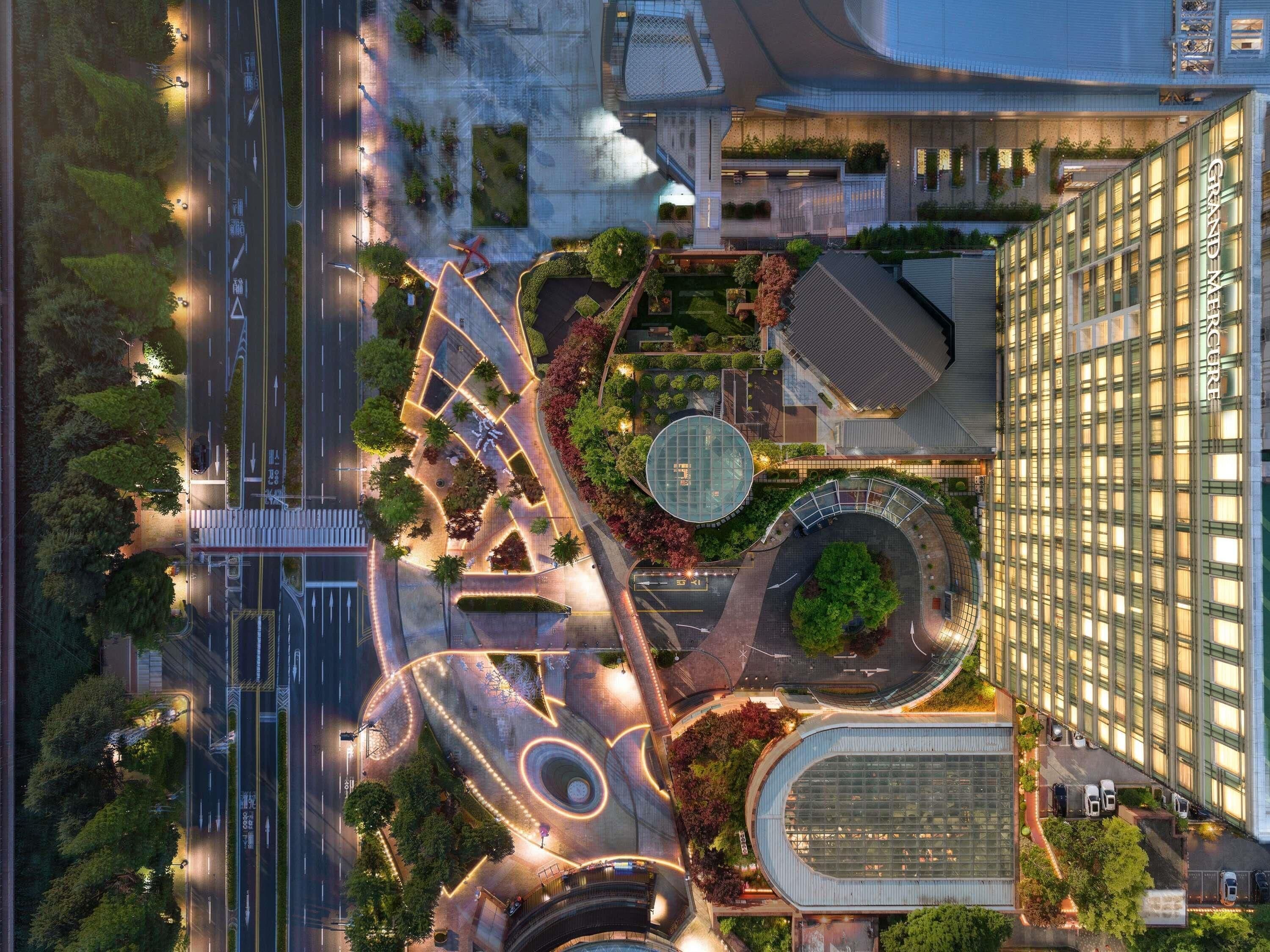 An aerial view of a modern urban area with a prominent building labeled 'GRAND MERCIFER.'