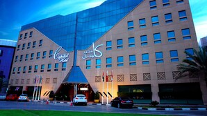 A hotel with a modern facade, multiple windows, and a prominent entrance. - Capitol Hotel (Dubai)
