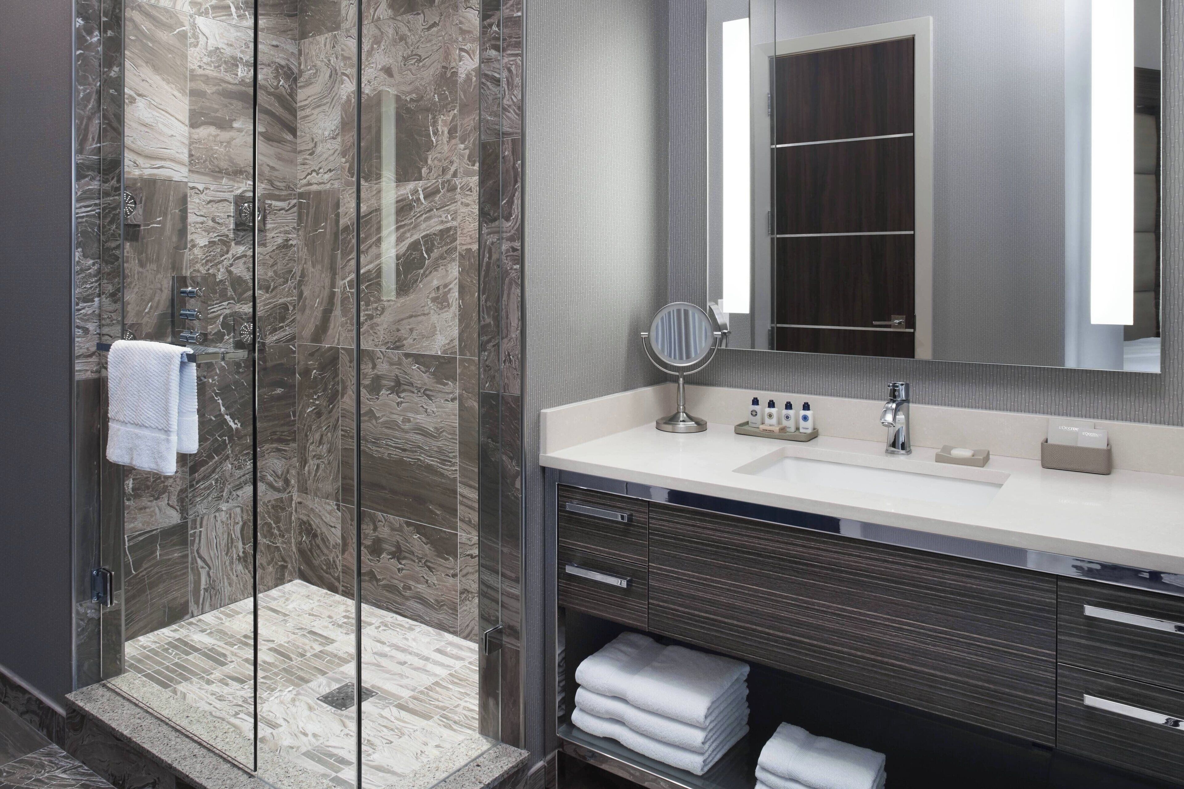 rainfall showerhead, designer toiletries, hair dryer, towels