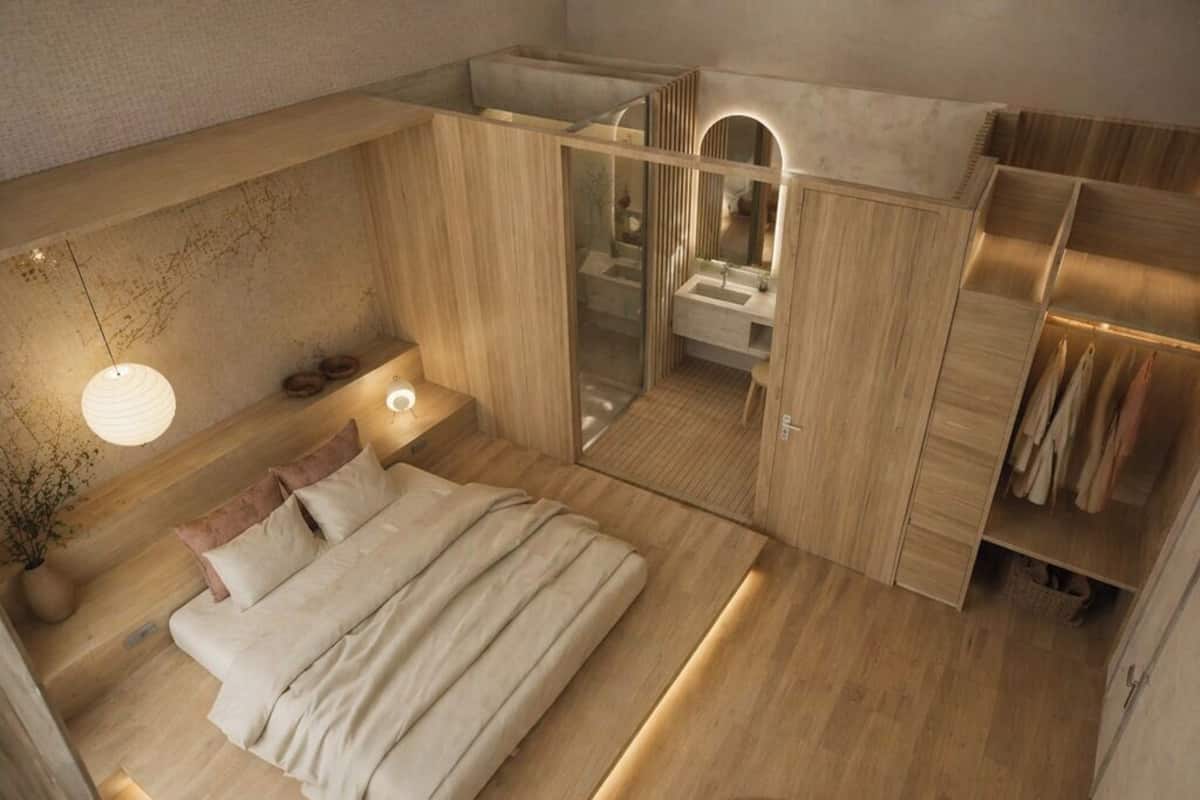 Une chambre à coucher moderne avec un lit, des tables de chevet, un miroir et une armoire.