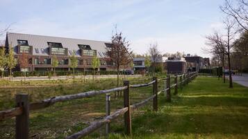 Stunning building with a flat roof and grassy area.