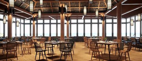 A spacious dining area with high ceilings, large windows, and wooden flooring. Tables and chairs are arranged for dining.