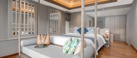 A modern bedroom with a large bed, a hanging chair, and a wooden ceiling.