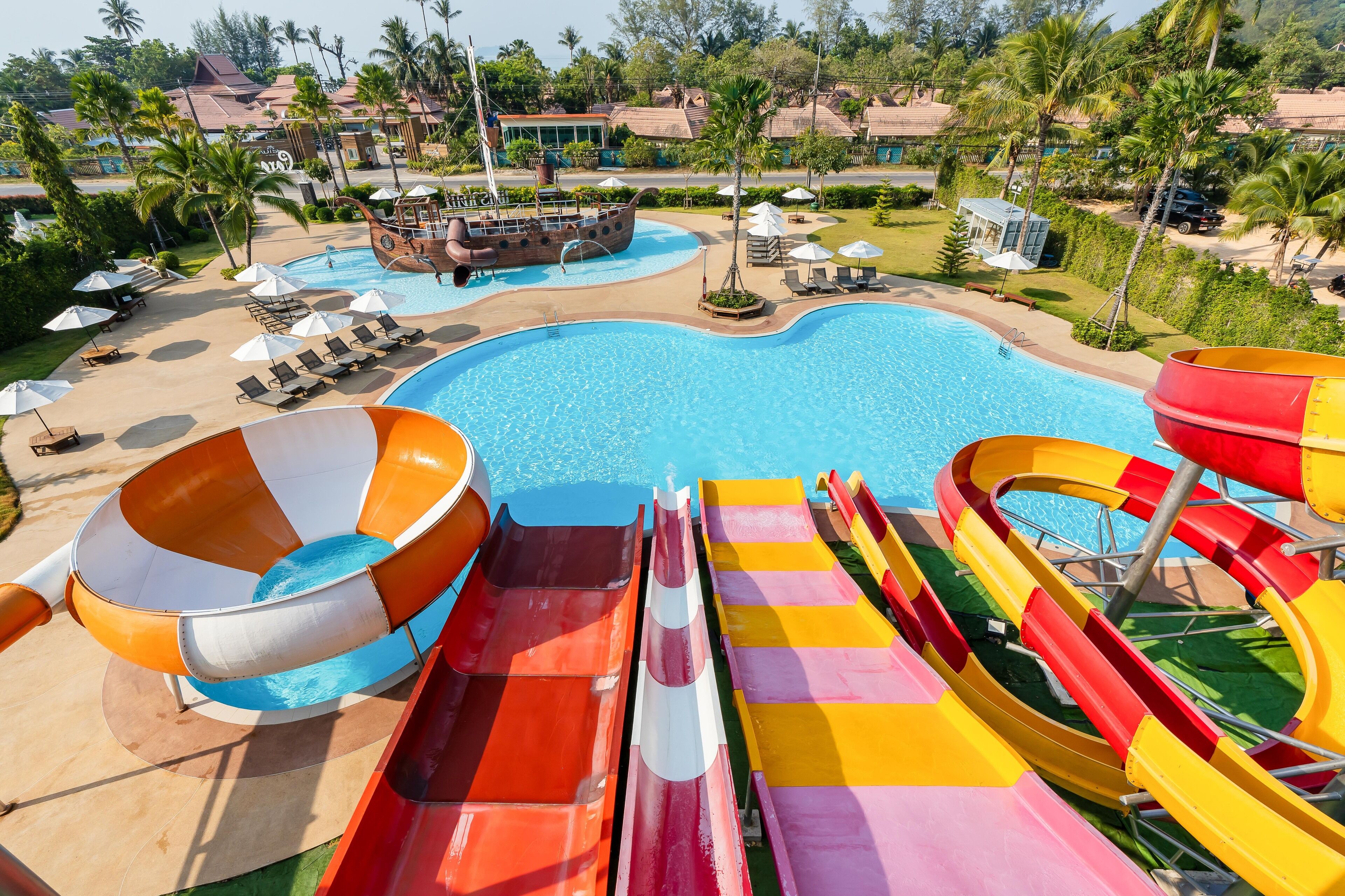 A water park with multiple slides and a pool.