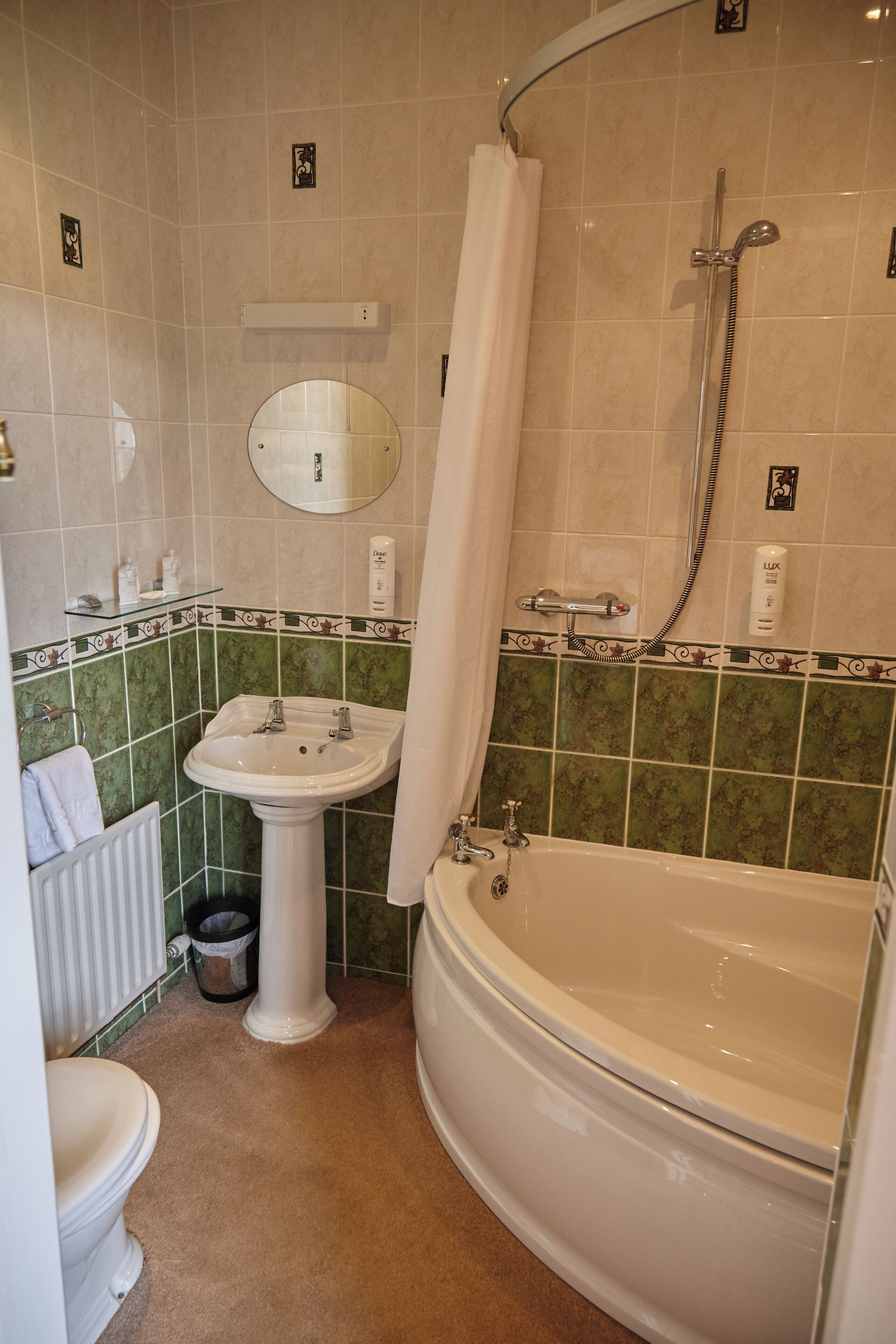 A bathroom with a sink, toilet, and bathtub.