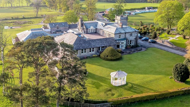 A large estate with multiple buildings, a well-maintained lawn, and a gazebo. - Hundith Hill Hotel (Cockermouth)