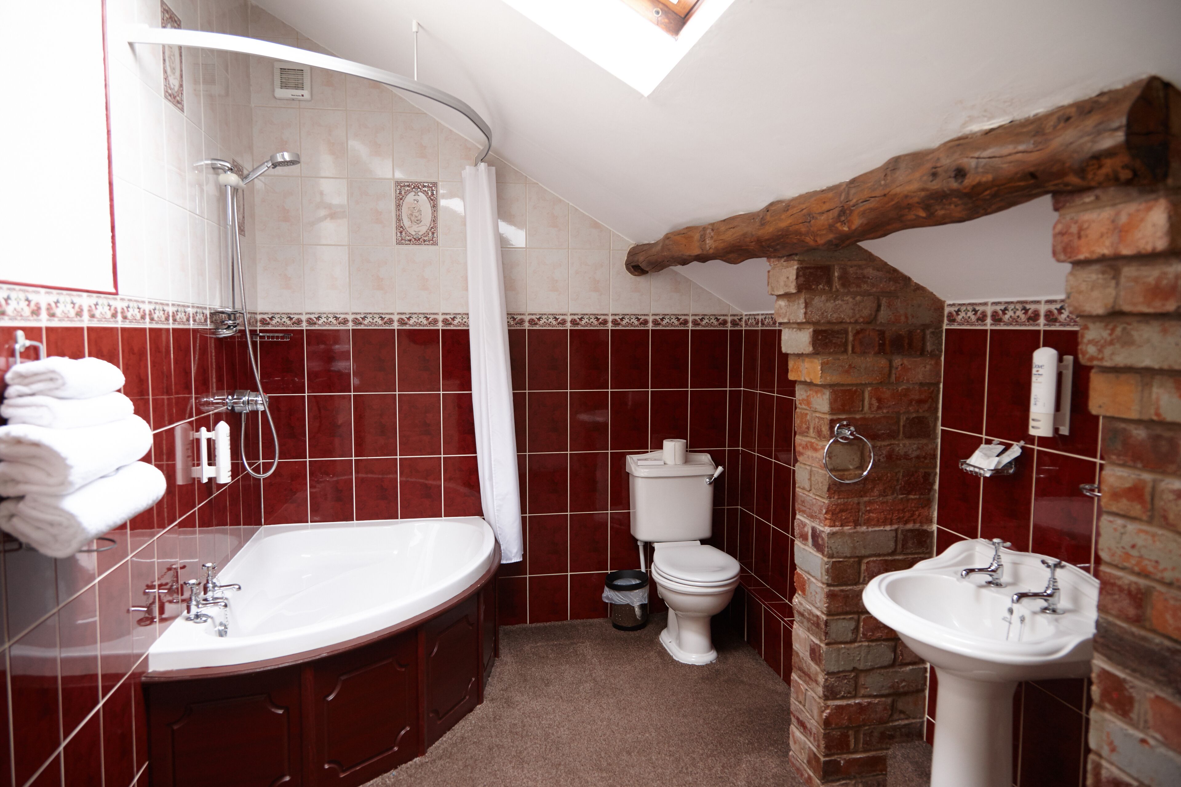 A bathroom with a bathtub, a shower, a toilet, and a sink.