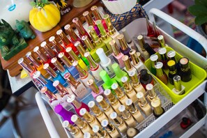 A cart filled with various bottles of perfume and cologne. - Golden Beach Resort (Krabi)