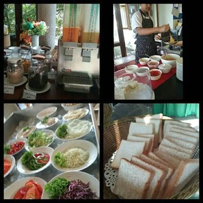 A buffet setup with various food items and a person serving. - Golden Beach Resort (Krabi)