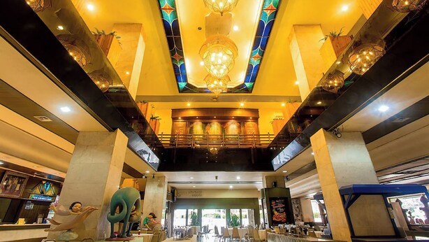 A spacious lobby with a high ceiling, decorative lighting fixtures, and a central staircase. - Pailyn Hotel Phitsanulok (Phitsanulok)
