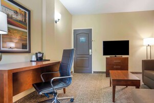 Suite, 1 King Bed, Non Smoking | Desk, laptop workspace, iron/ironing board, travel crib